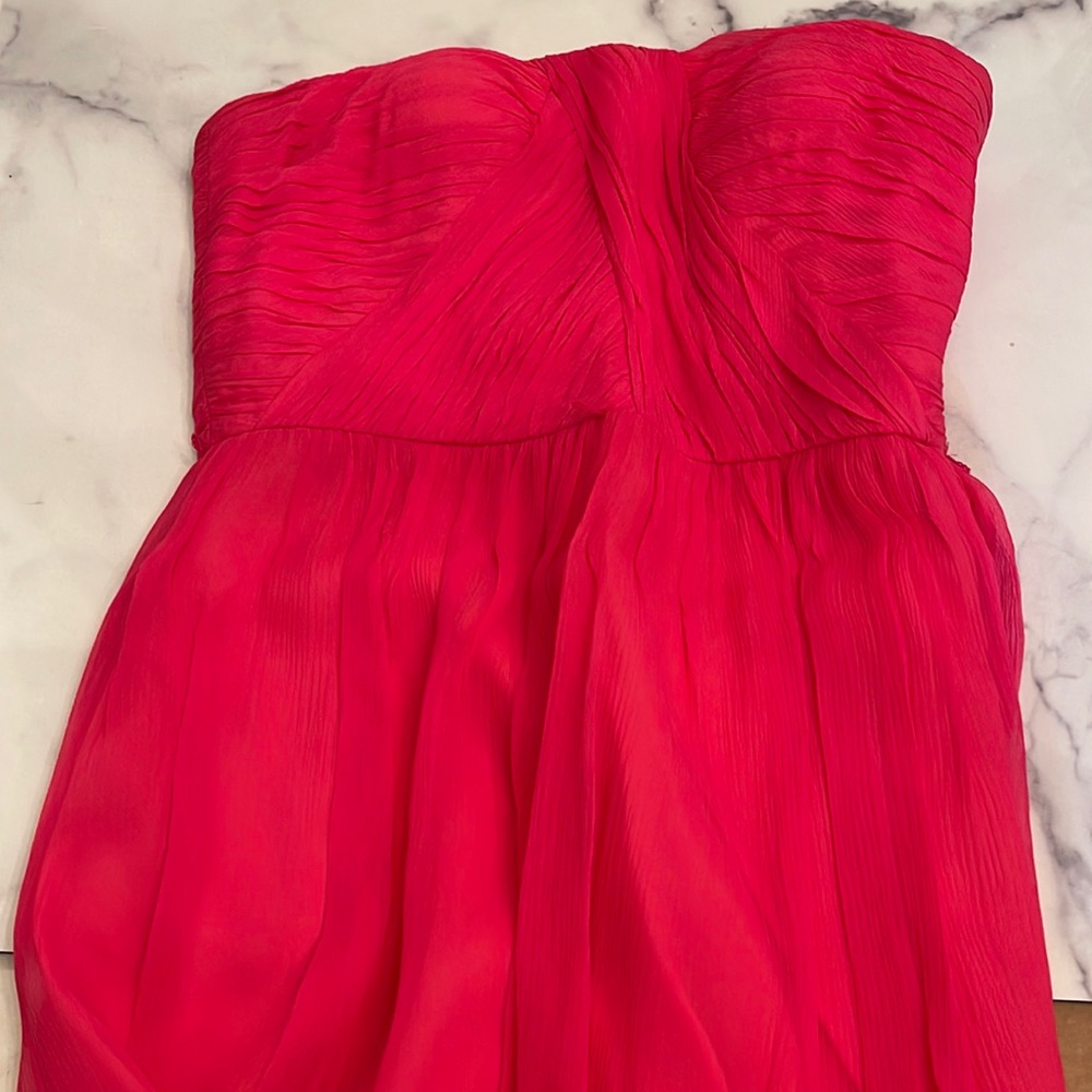 Strapless fuchsia pink bridesmaids dress with a ruched top. Size 8.
